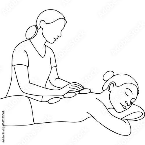 Woman receiving hot stone therapy during massage in wellness setting  
