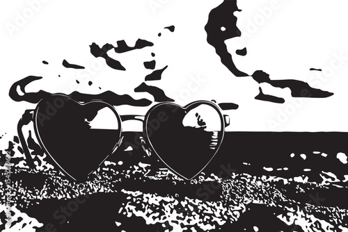 Heart shaped sunglasses on sand reflecting beach and sky with clouds in a summer day setting