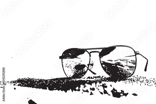 Sunglasses resting on a sandy beach reflecting the sky and ocean on a bright sunny day scene