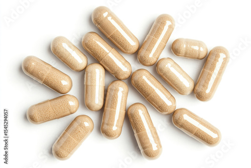 Beige capsules and single tablet on white background