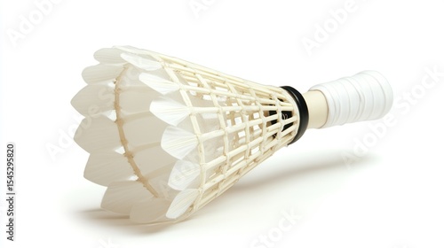 Shuttlecock resting, feathers angled, white plastic structure against white background