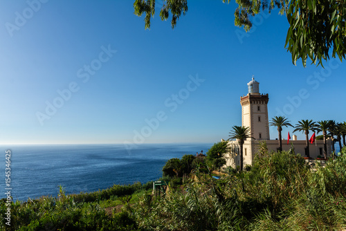 Cape Spartel lighthouse near Tangier, Morocco, overlooking the meeting point of the Atlantic Ocean and Mediterranean Sea on a clear, sunny day