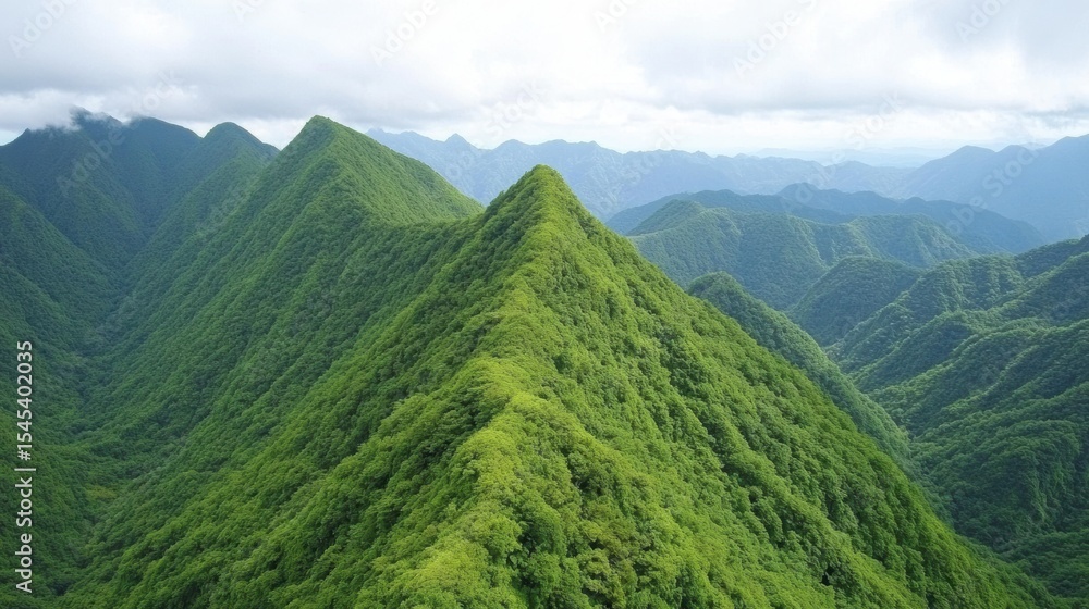 Fototapeta premium Lush green mountains rise majestically under a cloudy sky, showcasing a stunning view of undulating peaks and valleys, perfect for travel promotions, nature magazines, and calming decor,