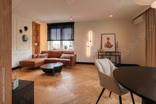 Elegant contemporary living room featuring warm wooden textures, ambient wall lighting, minimalist decor, and a cozy designer sofa in a modern luxury apartment.