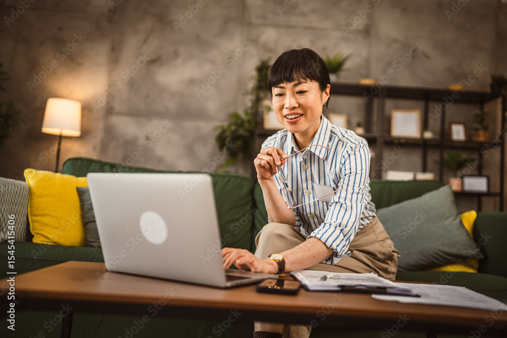 Mature japanese woman work from home on laptop Mature japanese woman work from home on laptop