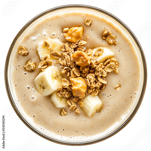 Granola and Banana Topped Smoothie in a Glass Bowl