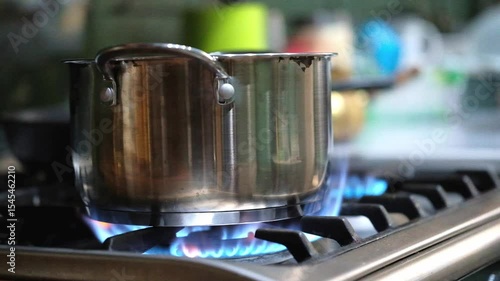 Food cooking in saucepan on open fire gas stove. Concept natural gas is burned in a home stove.