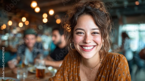 A joyful woman enjoys her time at a lively restaurant, radiating warmth and happiness, surrounded by a cheerful atmosphere and good company, perfect for socializing.