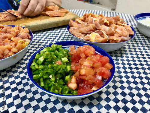 Food Prep on Checkered Tablecloth with Chicken and Vegetables