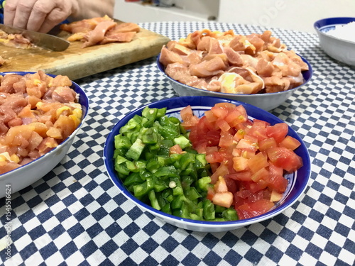 Food Prep on Checkered Tablecloth with Chicken and Vegetables