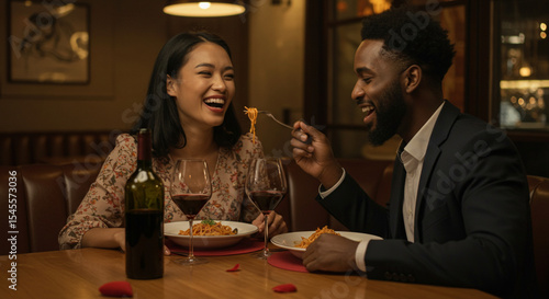 Happy couple having romantic dinner in restaurant, eating pasta and drinking red wine. Happy Valentine day concept