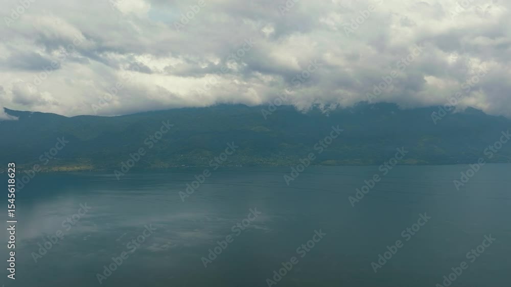 Aerial drone of Lake Singkarak among the mountains in West Sumatra, Indonesia. Aerial drone of Lake Singkarak among the mountains in West Sumatra, Indonesia.