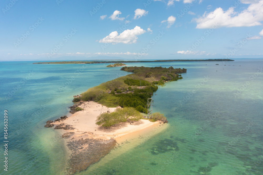 Obraz premium Island surrounded by coral reefs. Sandy beaches in Bantayan, Cebu. Boat running on water. Philippines.