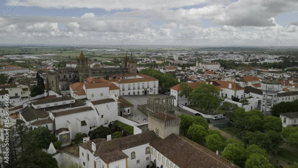 Drone floats to the left over Diana Gardens with the cathedral in the background on a partially cloudy day in Evora, Portugal Drone floats to the left over Diana Gardens with the cathedral in the background on a partially cloudy day in Evora, Portugal
