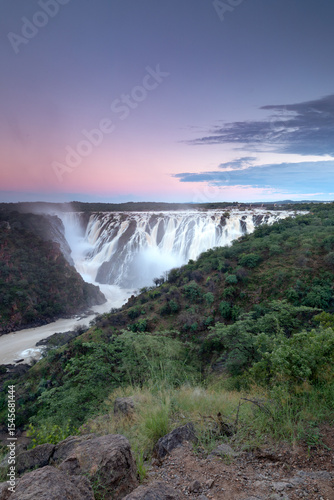 Ruacana Falls under a pastel Sky.