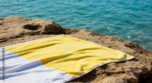 Yellow and White Beach Towel on Rocky Coastline