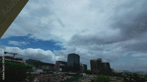 Time lapse video of an early morning scene with buildings and a cloudy sky during the monsoons at Pune India.