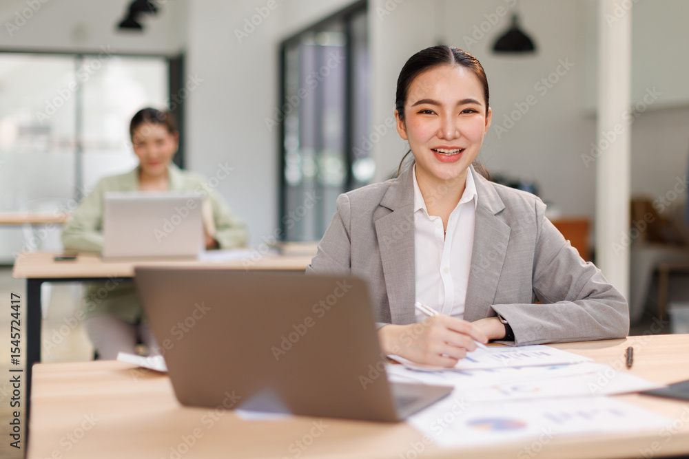 Asian professional analyst business woman sitting at office desk working on laptop thinking on project plan, analyzing marketing or financial data online, watching elearning webinar.
Asian professional analyst business woman sitting at office desk working on laptop thinking on project plan, analyzing marketing or financial data online, watching elearning webinar.