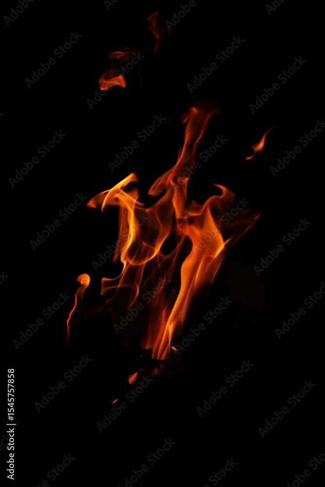 Fototapeta premium Fire flames on black background. Closeup of fire flames isolated on black background