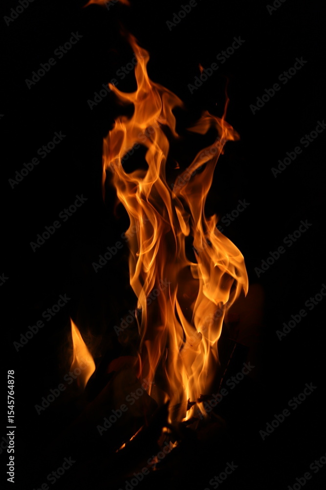 Fototapeta premium Fire flames on black background. Closeup of fire flames isolated on black background
