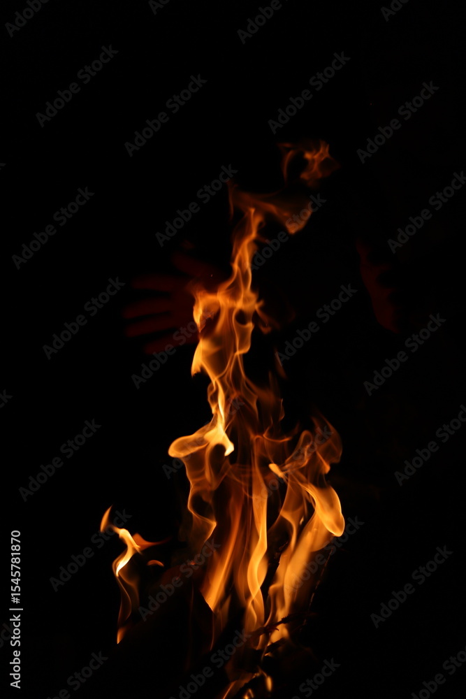 Fototapeta premium Fire flames on black background. Closeup of fire flames isolated on black background