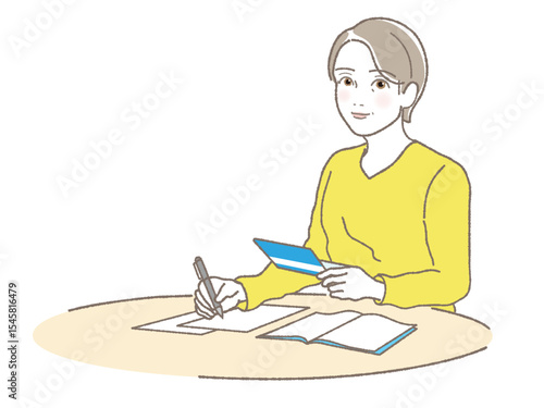 通帳を持って書類に記入する中高年女性