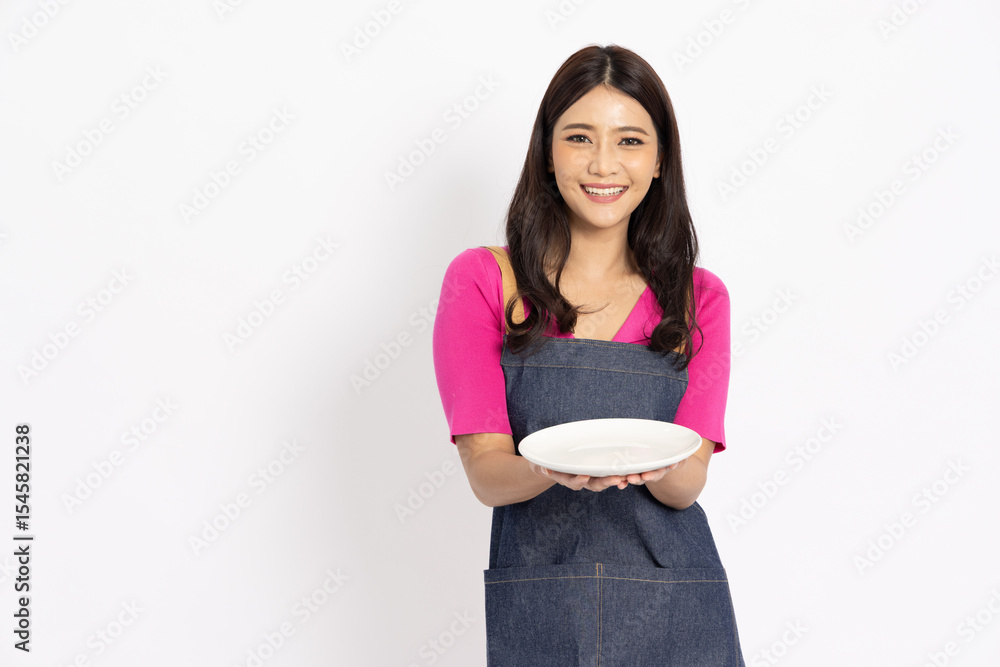 Fototapeta premium Young Asian woman with apron holding empty white plate or dish isolated on white background, Small restaurant owners sme concept
