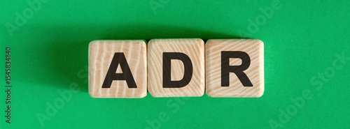 ADR text on a green background on wooden cubes