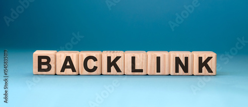 Backlink - text concept on wooden cubes with blue background