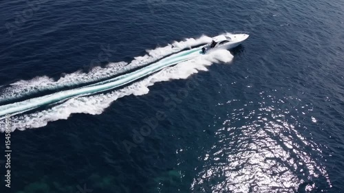 Wallpaper Mural Speedboat on the Ocean: A sleek, fast speedboat cuts through the deep blue ocean, leaving a long white wake in its path. The sun glints off the water's surface, creating a sparkling effect. Torontodigital.ca
