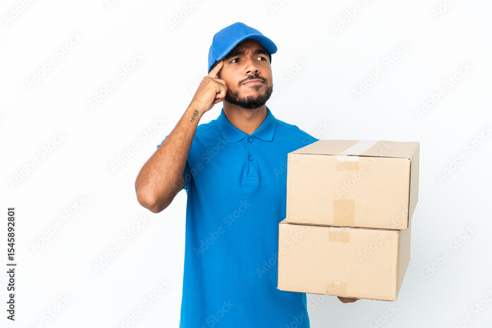 Delivery Ecuadorian man isolated on white background having doubts and thinking Delivery Ecuadorian man isolated on white background having doubts and thinking