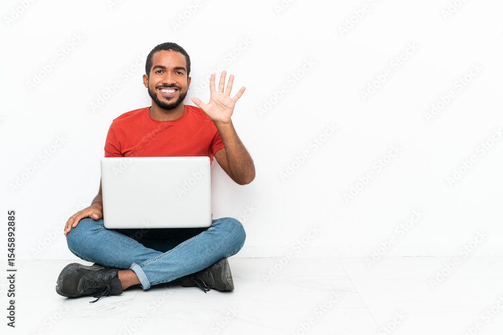 Young Ecuadorian man with a laptop sitting on the floor isolated on white background counting five with fingers Young Ecuadorian man with a laptop sitting on the floor isolated on white background counting five with fingers