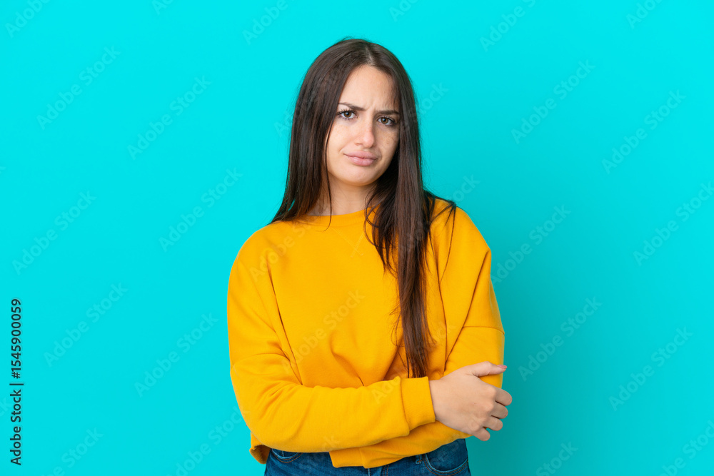 Obraz premium Young Ukrainian woman isolated on blue background feeling upset