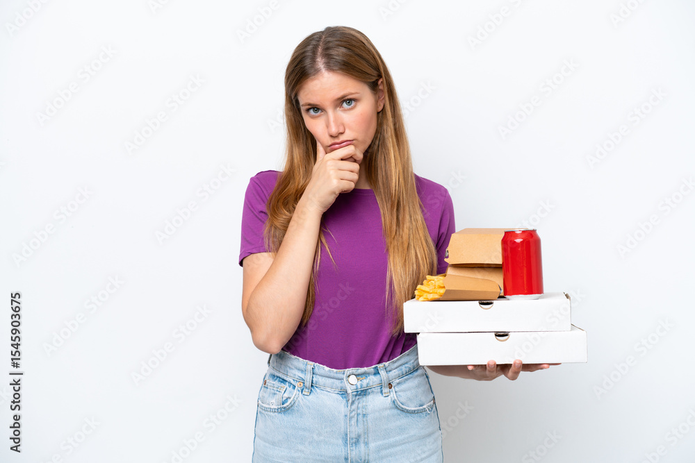 Young pretty blonde woman holding fast food isolated on white background thinking Young pretty blonde woman holding fast food isolated on white background thinking