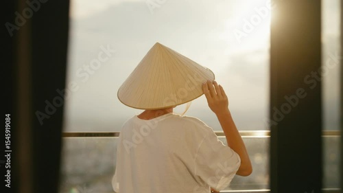 A Contemplative Moment with a Traditional Conical Hat Experienced at Beautiful Sunset