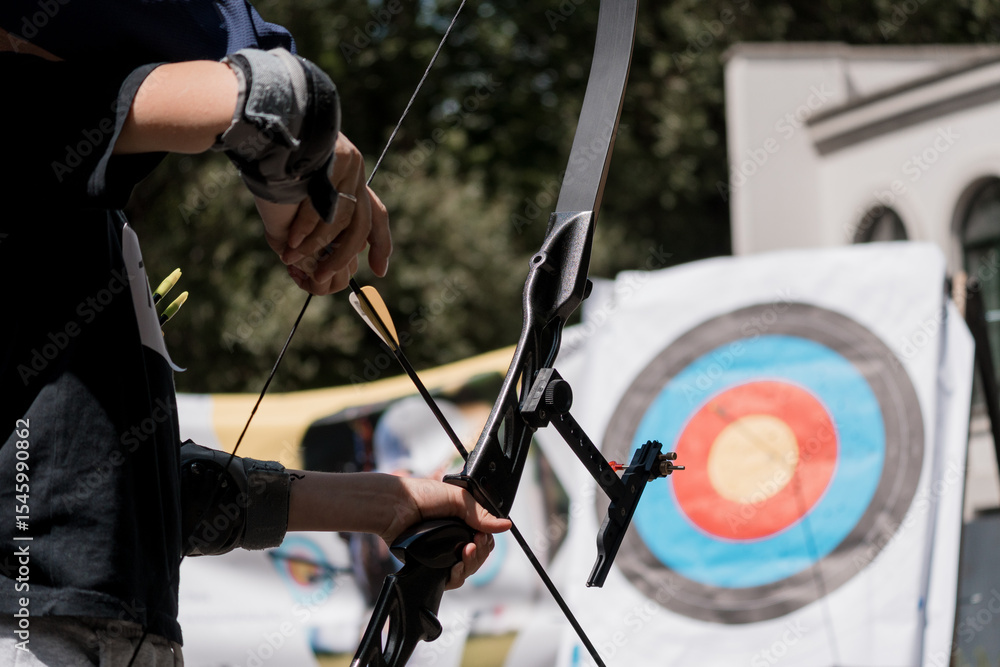 Intense Archery Practice: Young Archer Aiming Bow at Target, Outdoor Range, Blue, White and Green Color Scheme Intense Archery Practice: Young Archer Aiming Bow at Target, Outdoor Range, Blue, White and Green Color Scheme