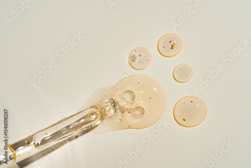 Top-view mockup of a glass dropper bottle with cosmetic pipette on trendy beige backdrop. Harsh sunlight accentuates the organic beauty product's premium packaging for clean cosmetics branding.