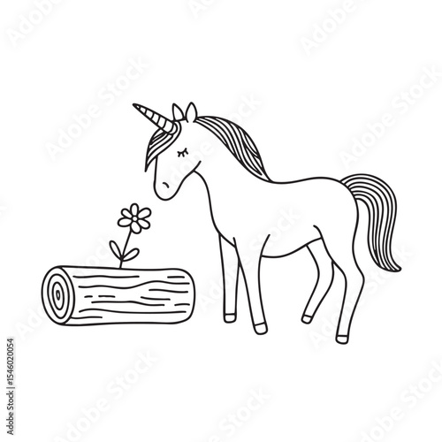 A unicorn sniffing a flower next to a log lying on the ground