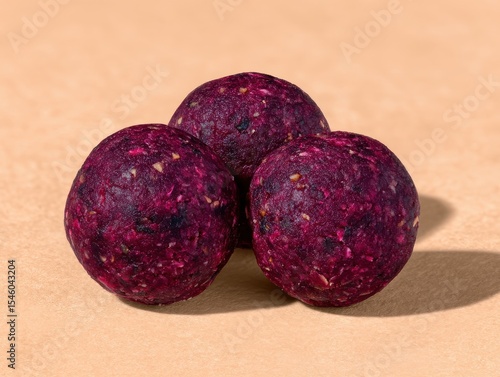 Nutrient-rich energy bites crafted from purple dragon fruit set on a warm pastel background delivering a vibrant healthful snack option embodying creativity and nourishment