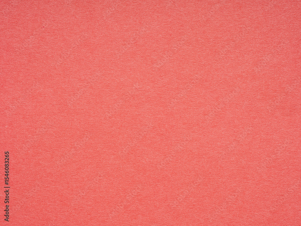 Fototapeta premium The textured coral surface of the paper exudes a serene warmth, inviting touch and inspiration