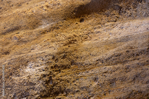 Fotografie Texture or background of a stone tuff wall in brown colors