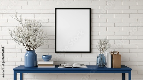Obraz na płótnie Empty Black Frame Wall Decor with Blue Console Table and Books in Minimalist Hom