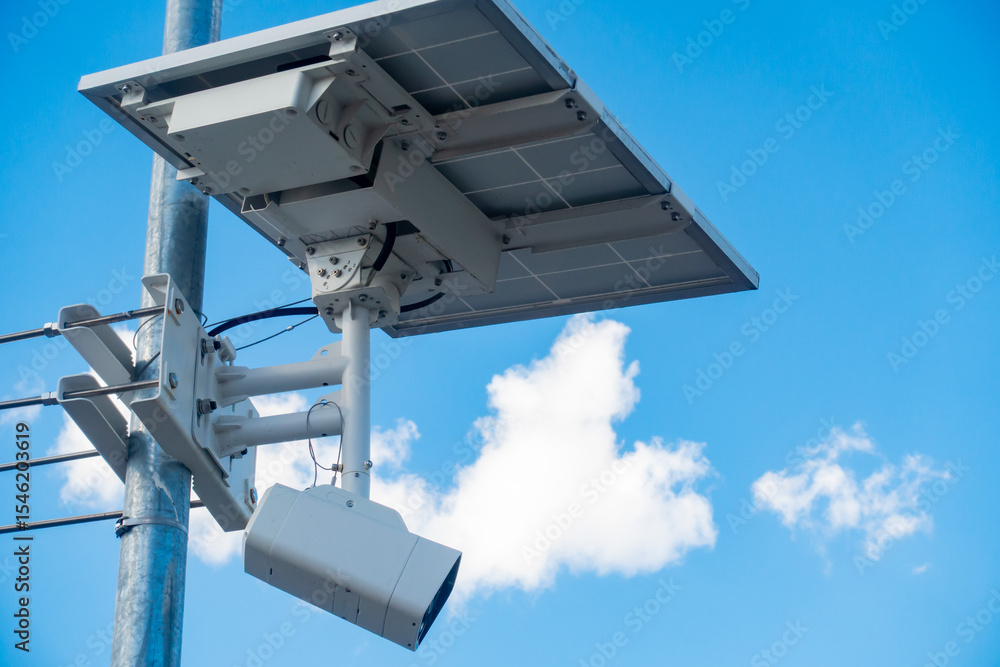 屋外に設置された太陽光パネル付きの監視カメラの写真。 屋外に設置された太陽光パネル付きの監視カメラの写真。
