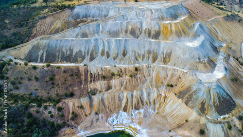 Aerial view of Tsar Asen Mine, Bulgaria – colorful terraced slopes of a former open-pit mine where non-ferrous metals, especially copper, were once extracted. Nature slowly reclaims the site.