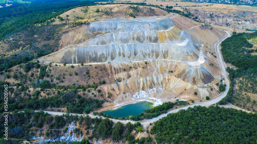 Aerial view of Tsar Asen Mine, Bulgaria – colorful terraced slopes of a former open-pit mine where non-ferrous metals, especially copper, were once extracted. Nature slowly reclaims the site.
