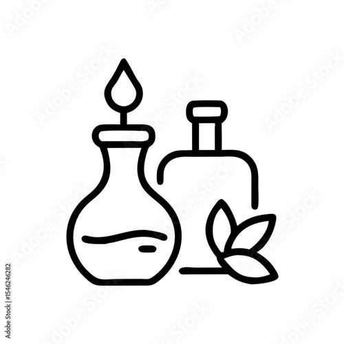 Glass bottles of essential oils with green leaves in minimal style  
