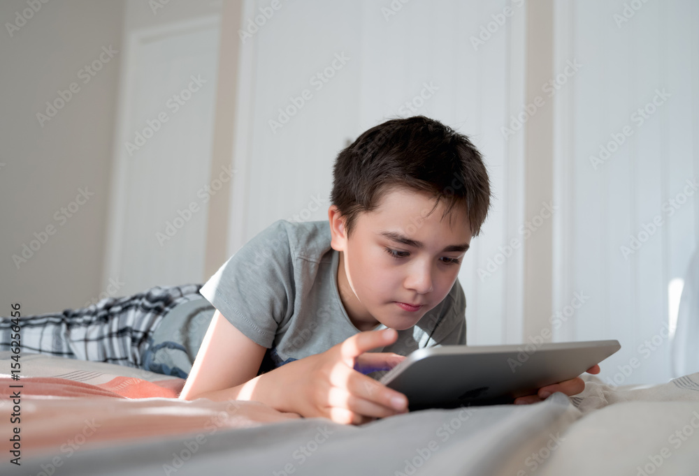 Kid Online Education,Asian Child using tablet computer Ai technology for homework,Schoolboy watching online movie, cartoon,playing virtual in bed,Concept Kid and digital technology addiction Kid Online Education,Asian Child using tablet computer Ai technology for homework,Schoolboy watching online movie, cartoon,playing virtual in bed,Concept Kid and digital technology addiction