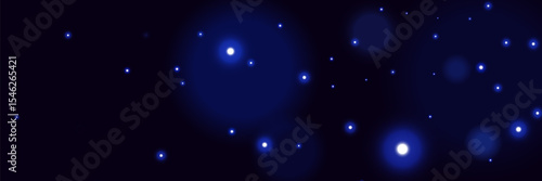 Blue glowing particles on dark background with soft bokeh light effect and dreamy cosmic atmosphere