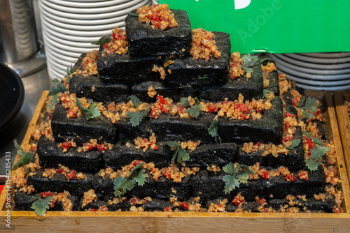 Photography Pyramid of black stinky tofu, a beloved street snack in Shanghai, China