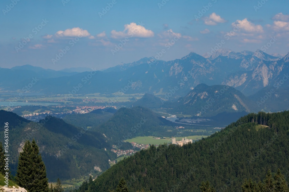 Obraz premium Scenic mountain view of the Füssen region in Germany showcasing valleys and peaks under a clear sky
